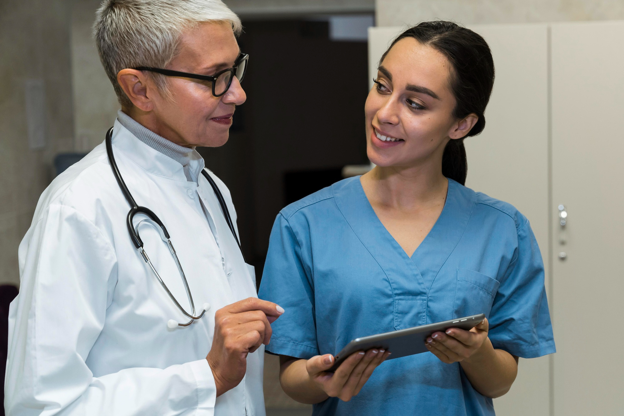 ThriveWell Care NDIS clinical team reviewing participant care plan on tablet Melbourne — registered disability and mental health support provider Victoria